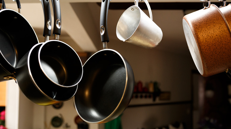 Pots and pans hanging from rack